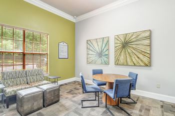 a conference room with a table and chairs and a window